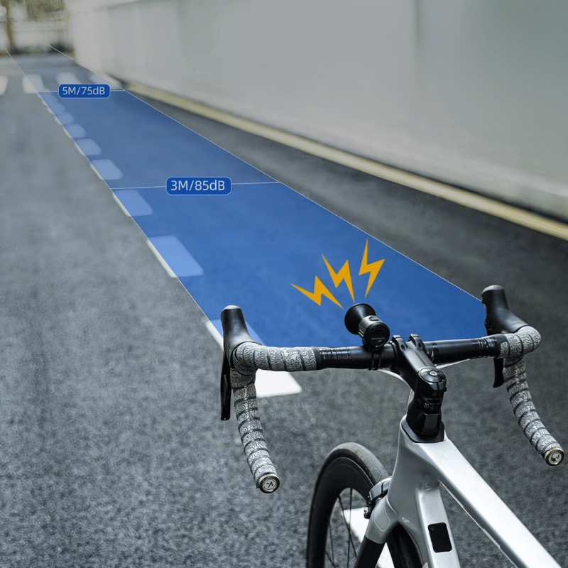 Cyclist using loud bike bell while riding on urban cycle lane – ensures safe navigation in city traffic.