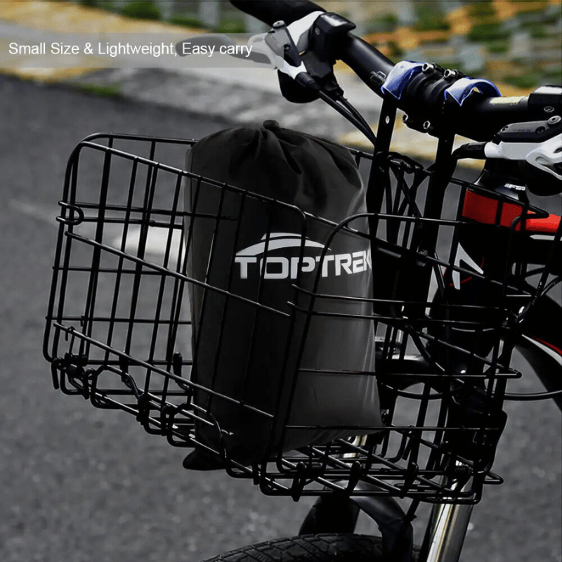 Compact black bike cover in carry pouch placed inside a front bicycle basket