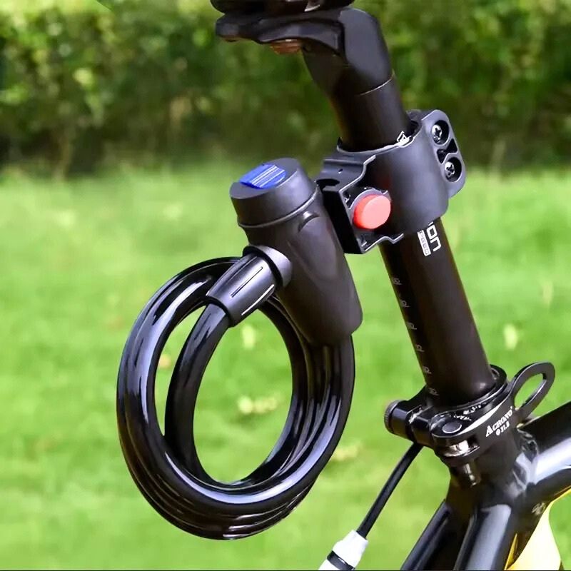 Coiled bike lock attached to a bike seatpost with included mounting bracket, shown outdoors