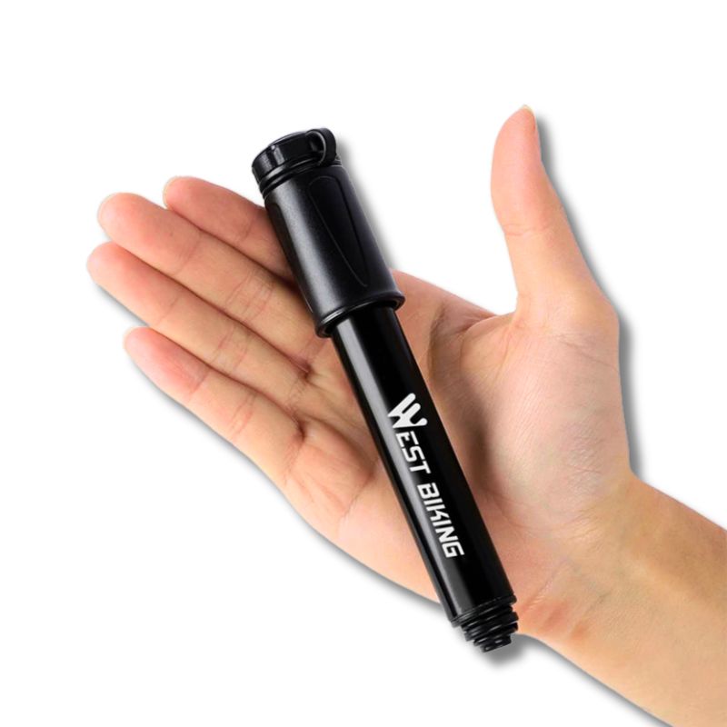 Mini bike pump held in hand showing compact size and black design