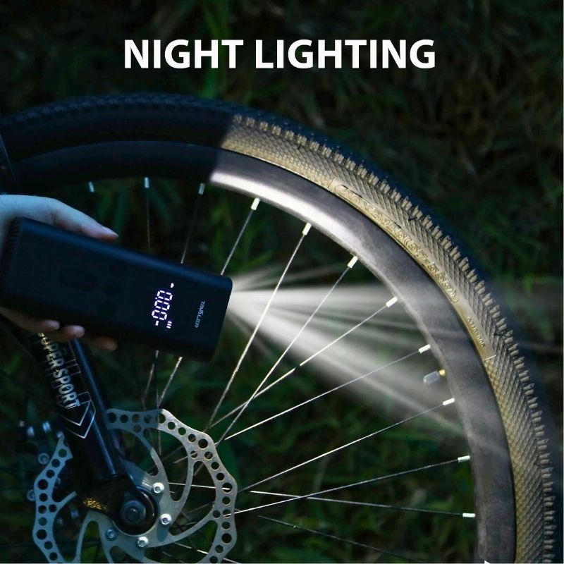Tyre pump in use at night showing built-in LED light
