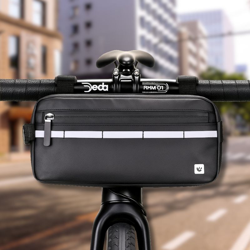 Waterproof black bike handlebar bag securely attached to the front of a city bike