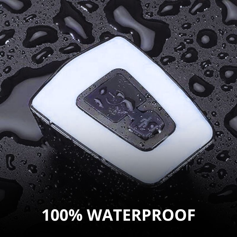 Waterproof LED bike light with water droplets.