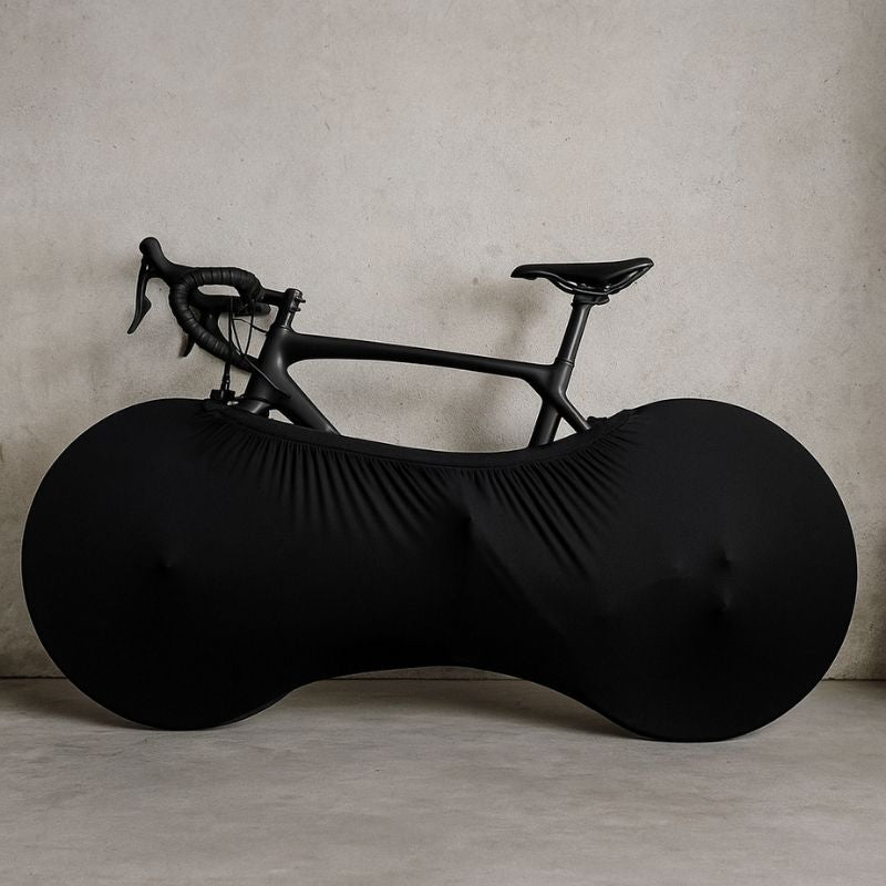 Black stretch bike cover on bicycle indoors protecting the floor from dirt