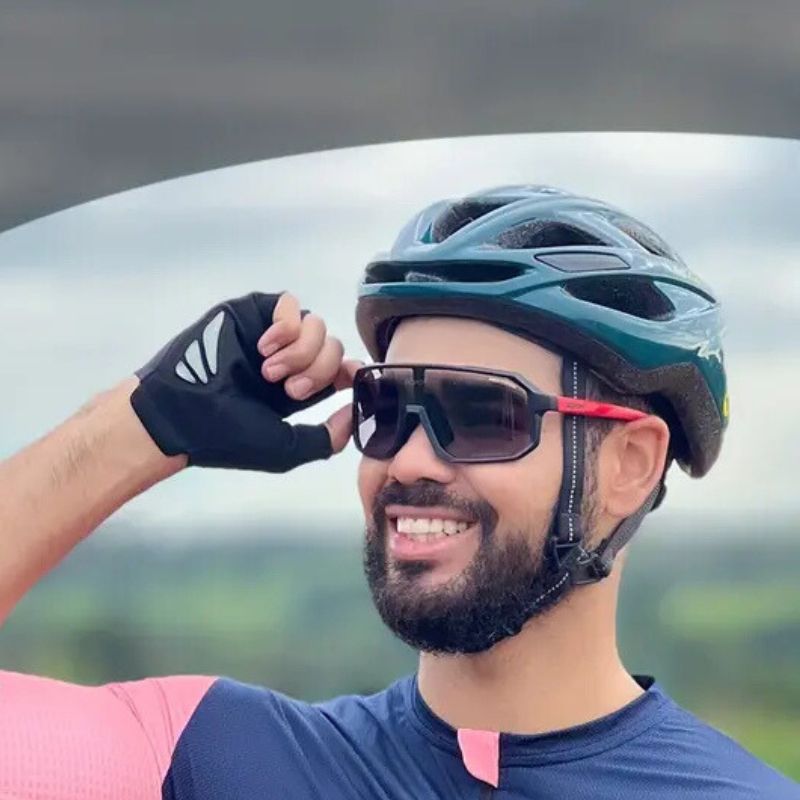 Clear cycling glasses with adaptive lenses worn on road