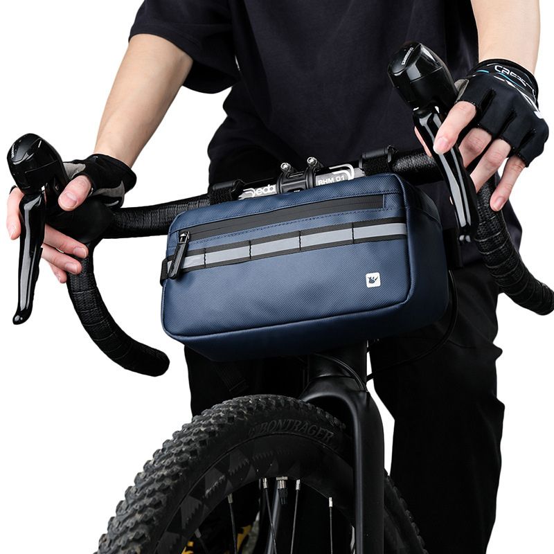 Blue waterproof bike handlebar bag centered on front bar, ready for adventure