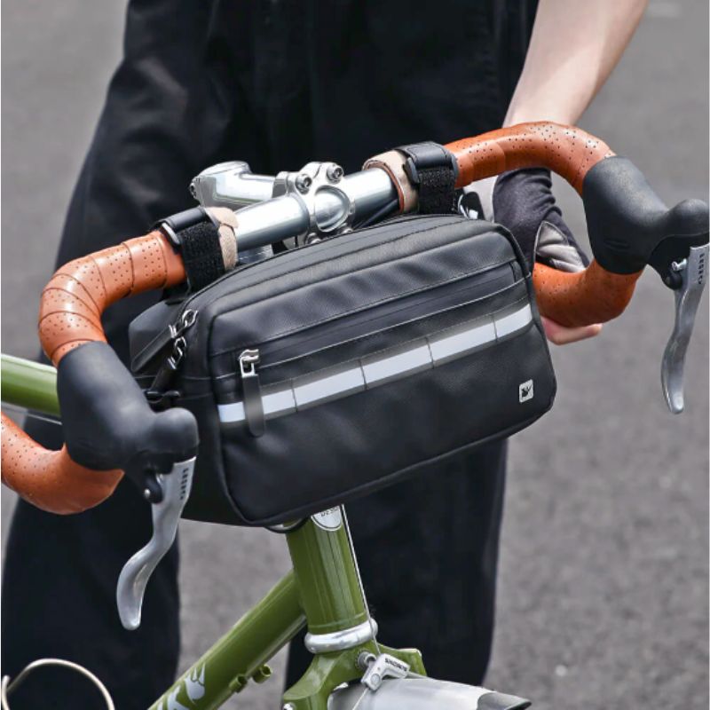 Compact handlebar bag mounted on road bike, ideal for cycling gear storage