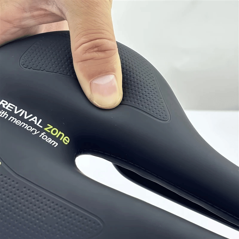 Hand pressing memory foam of black bike seat