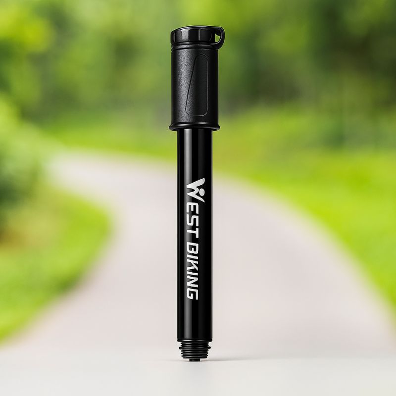 Compact pump resting on forest ground, ideal for outdoor cycling use